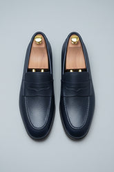 Midnight blue leather loafers with textured finish, perfect for business casual style.
